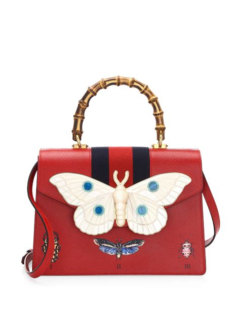 red gucci bag with butterfly